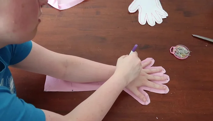 (Optional) Trace hand onto fabric: Retrace your hand on the fabric piece for a better fit.