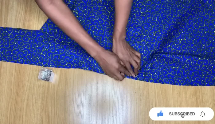 Pleat and sew the ruffle onto the dress hem.