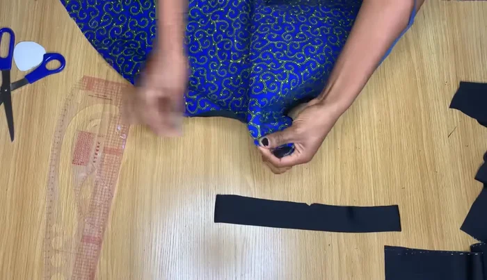 Attach the neckline band to the dress neckline, pinning and then stitching.