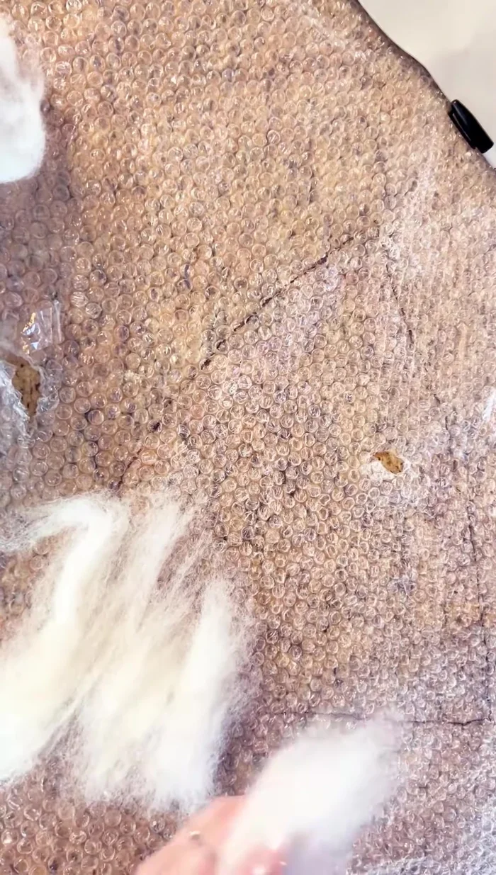 Fold the edges of the first hat section over the pattern.