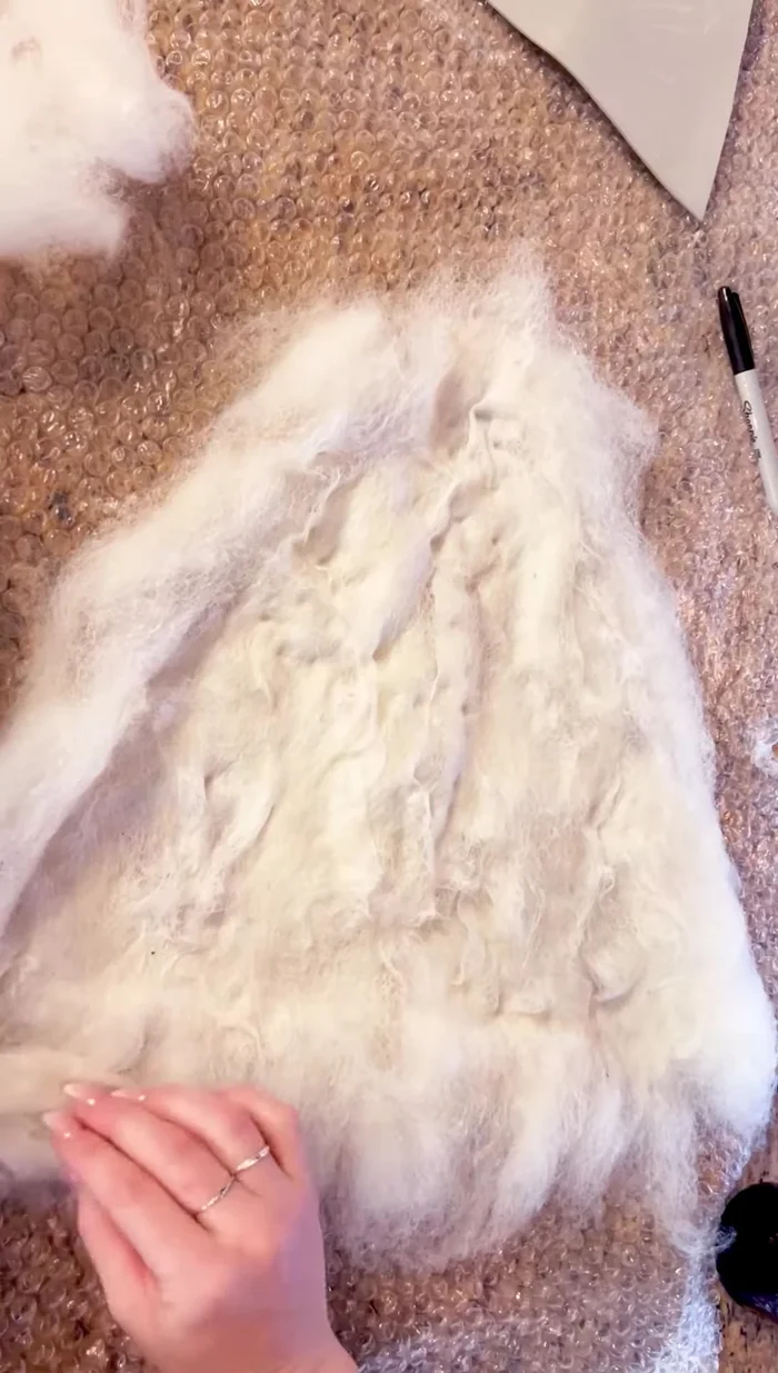 Fold the edges of the first hat section over the pattern.