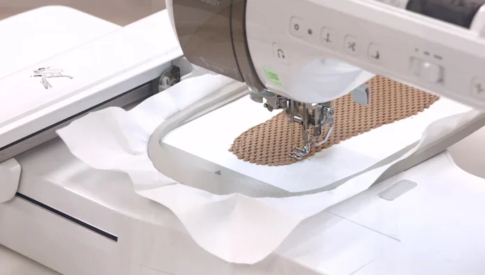 Run the placement stitch for the batting. Place the batting over the design, cover completely, and run the tacking stitch for the batting.