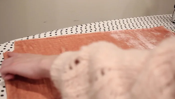 Create the smocking. Sew rows of elastic thread approximately two inches apart, starting a quarter inch from the hem. The first row may gather less; subsequent rows will gather more.