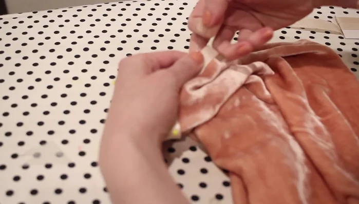 Attach twill tape (or bias tape) to the top of the sleeves. Pin along the top edge, leaving space for the underarm, and sew with a quarter-inch seam allowance. Turn under and top stitch to create a casing for the elastic.