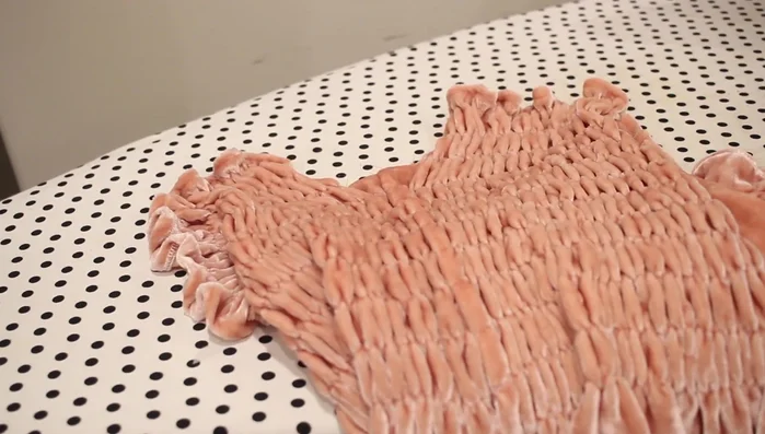 Attach sleeves to the shirt. Match sleeve and shirt side seams, pin at underarm, and sew with a half-inch seam allowance. Serge the underarm edges.