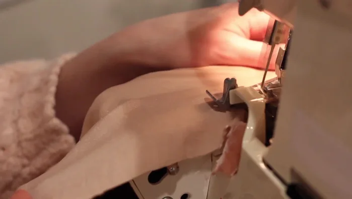 Hem the shirt bottom. Serge the edge, fold under, and top stitch.