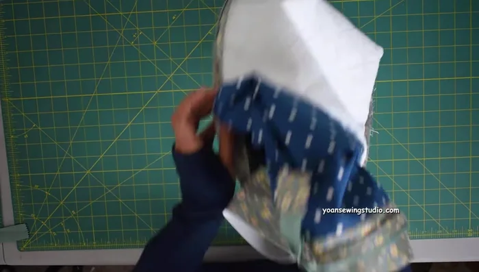 Insert interior into exterior shell. Sew around (1/2 inch seam allowance). Turn right side out through opening. Neaten and top stitch.