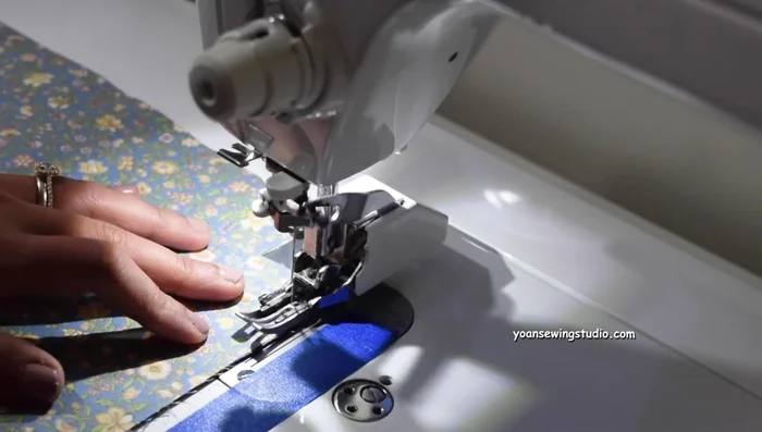 Baste stitch sides and bottom of the pocket (1/4 inch seam allowance). Trim excess zipper.