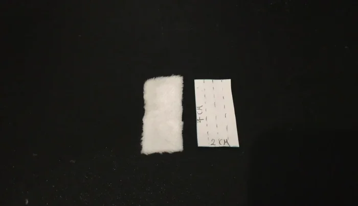 Make the side brush using three copies of part 13. Fold each piece, sew a small stitch on one end and in the middle, and then sew shut from the middle to the sewn end. Carefully cut the loose fabric into bristles. Attach the brushes to the underside of the Roomba, adding part 6 in yellow fabric for the center.