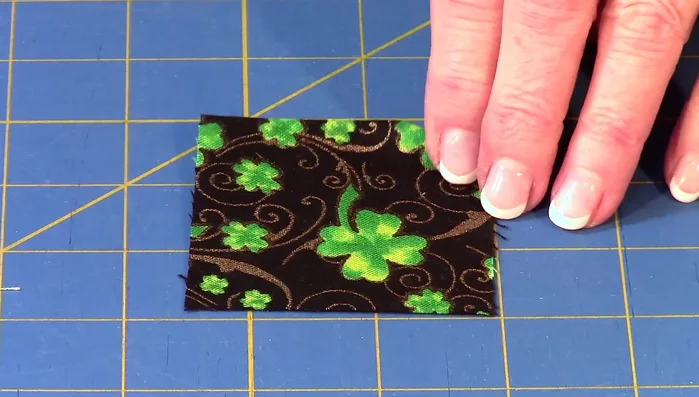 Apply letters: Remove paper backing from fusible web, place on fabric, and finger press. Cut out fabric letters along drawn lines.