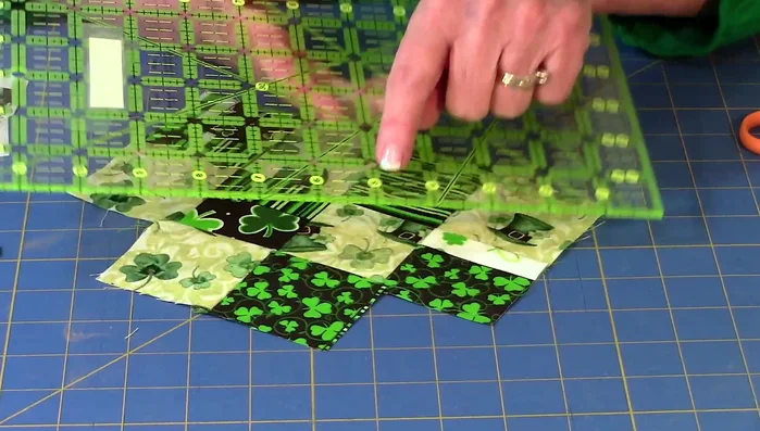 Trim excess fabric: Use a rotary cutter and ruler to trim the edges of the square sections for a clean finish, ensuring a 1/4 inch seam allowance. 