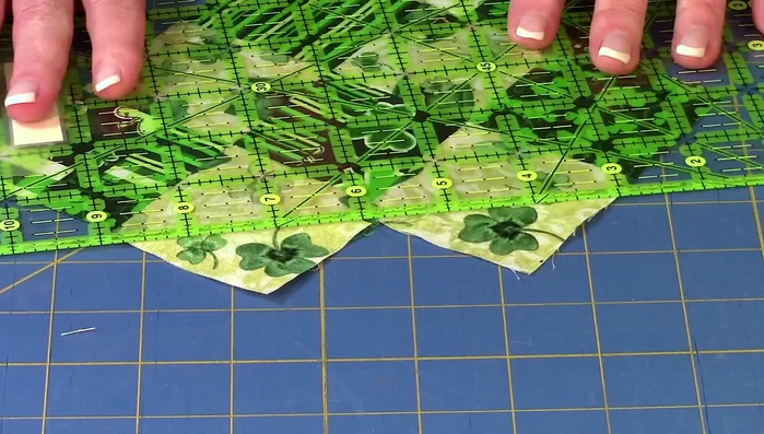 Trim excess fabric: Use a rotary cutter and ruler to trim the edges of the square sections for a clean finish, ensuring a 1/4 inch seam allowance. 