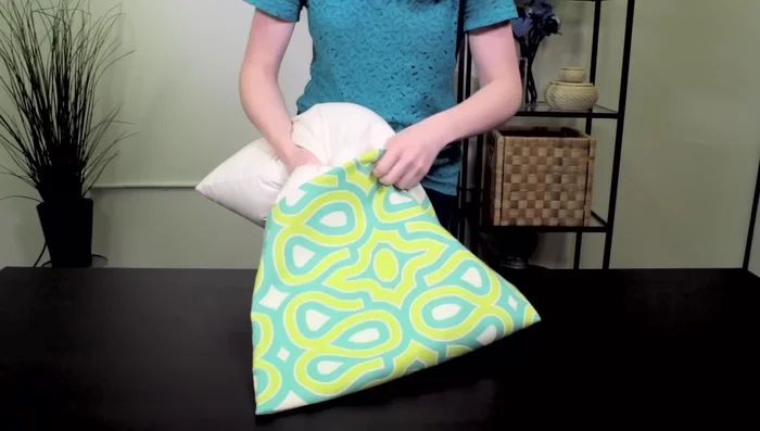 Insert the pillow form and arrange it to fill the cover.