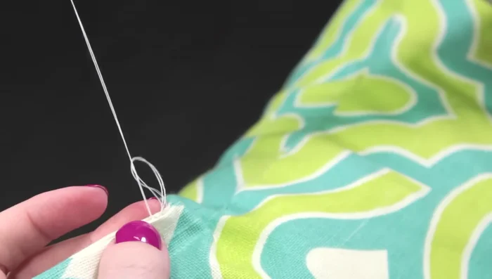 Secure the thread with knots at the beginning and end, hiding the thread tails inside the seam.