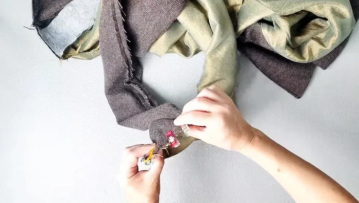 Secure the bottom facings with a 3/8 inch seam allowance. Sew the bottom hem of the jacket (2 inches), leaving an opening for turning. Clip corners, turn right side out, and edgestitch the opening closed.