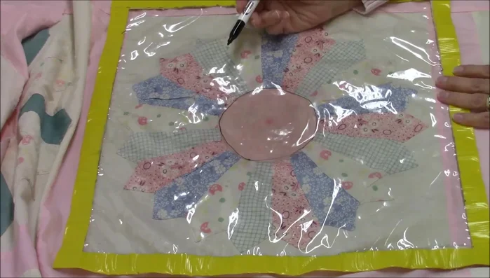 Use the guide to quilt three concentric circles on the Dresden plate center.