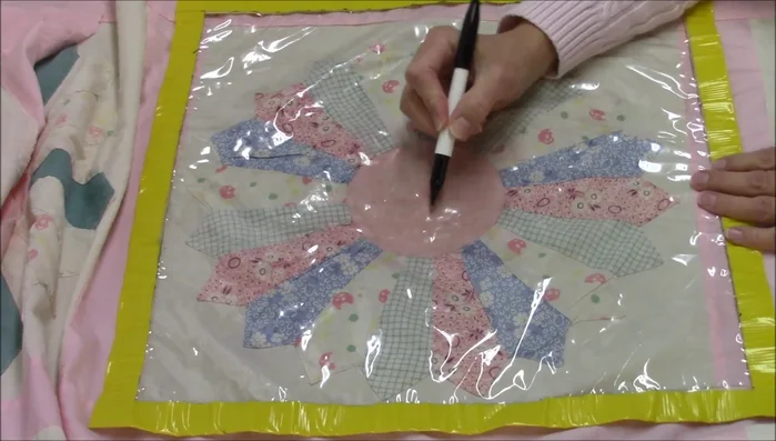 Use the guide to quilt two lines across in each direction on the Dresden plate center.