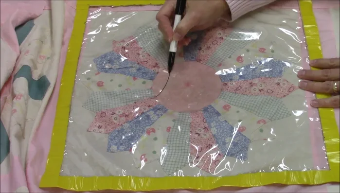 Draw a continuous curve pattern on plastic tablecloth.