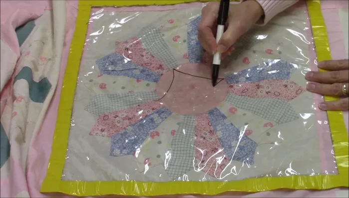 Use the guide to quilt a continuous curve around the Dresden plate center. Consider adding a flower in the center.