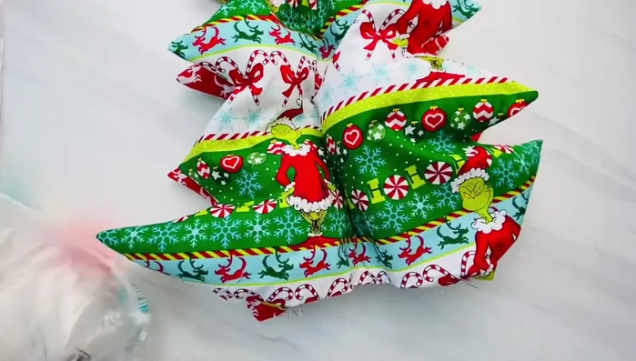 Stuff the tree: Stuff fiberfill through the bottom openings, pushing towards the top. Use a tool or fingers to distribute the filling evenly.