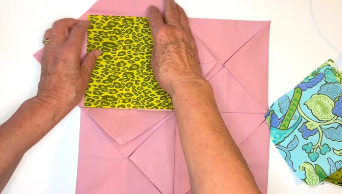 Insert Inner Windows: Open all flaps of the assembled unit and insert the inner window units (prepared bias squares), ensuring they fit snugly and match almost perfectly. Trim if necessary.