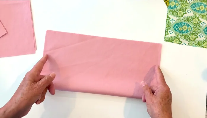 Create Bias Squares: Fold each square in half, sew a 1/4-inch seam on both sides, then fold it in half again and pin the middle. Sew a seam, leaving an opening for turning. Trim corners, turn right side out, and press.