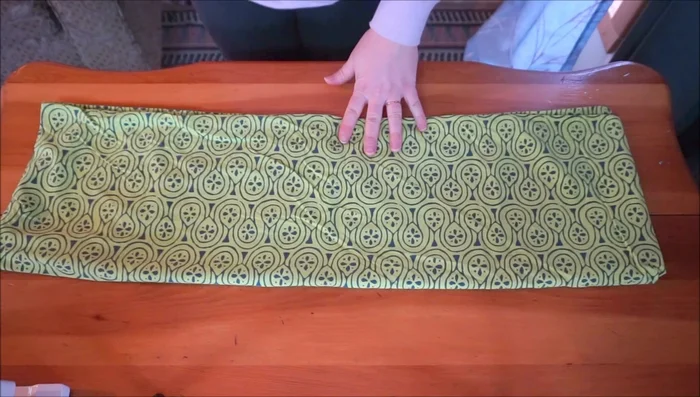 Cut out a fabric strip for the strap: 6 inches wide and 30 inches long (adjust for desired length and width). Fold it twice to make a 2-inch wide strap.