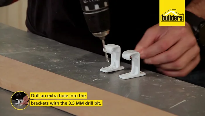 Install the brackets. Drill additional holes in the brackets if necessary (if using brackets with only one pre-drilled hole). Attach the brackets approximately 20mm down from the top of the pelmet using 13mm screws.