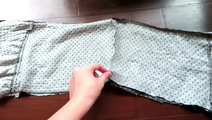 Turn it inside out and finish: Turn the fabric inside out through one of the open ends. This creates a long tube ready to wear as an infinity scarf.