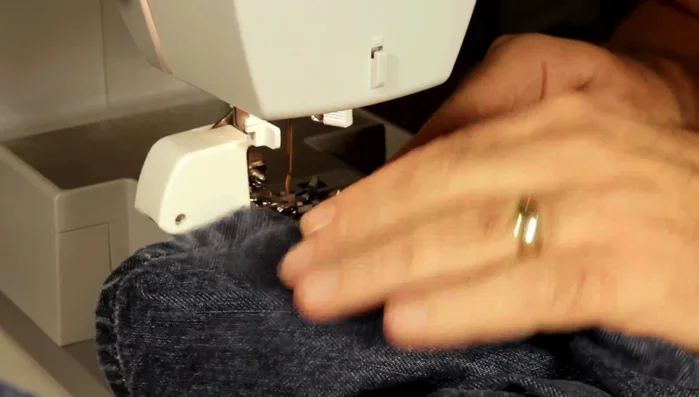 Sew a real hem on jeans, starting with a double stitch before the hump on the back seam.