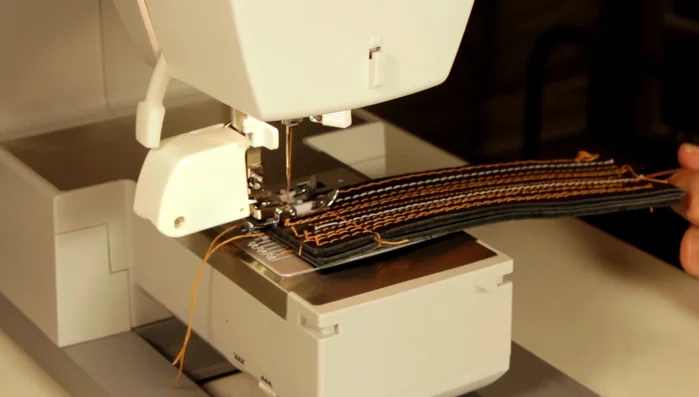 Sew multiple layers of medium-weight leather using a straight stitch (length 4, tension 7-8) with a size 16 denim needle. 