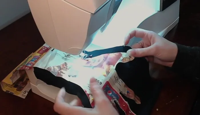 Sew along the outline of the hand turkey pattern, using a zigzag stitch. Go slowly, especially around the fingers.