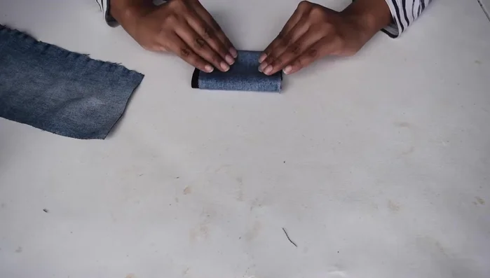 Fold the cloth into four layers and use a pre-cut circular template to cut out small circles.