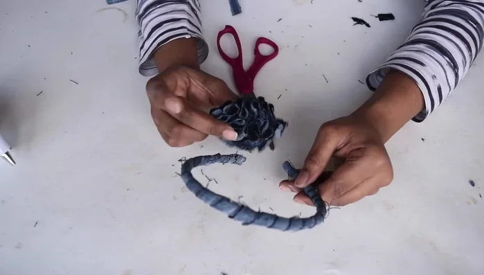 Attach the flower to the headband, approximately 1.5 inches from the center.