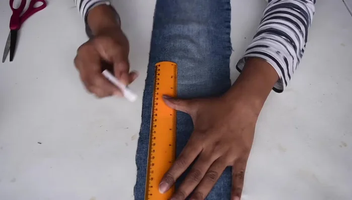 Fold the cloth into four layers and use a pre-cut circular template to cut out small circles.