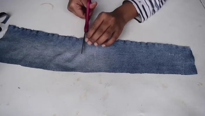 Fold the cloth into four layers and use a pre-cut circular template to cut out small circles.