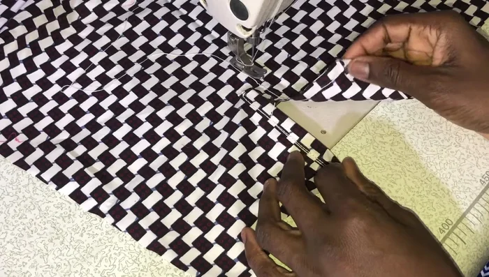 Turn the sleeve right side out and fold the placket edge over, covering the seam and band, and stitch.