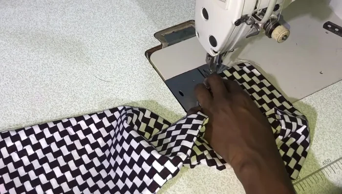 Close the band opening. Attach buttons and buttonholes (buttons on the band, buttonholes on the placket). Attach sleeves to the armholes.