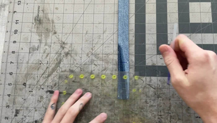 Sew the pinch point: Stitch from one pinch point to the other on the side with existing stitching, using the same stitch length as before to align with existing holes.