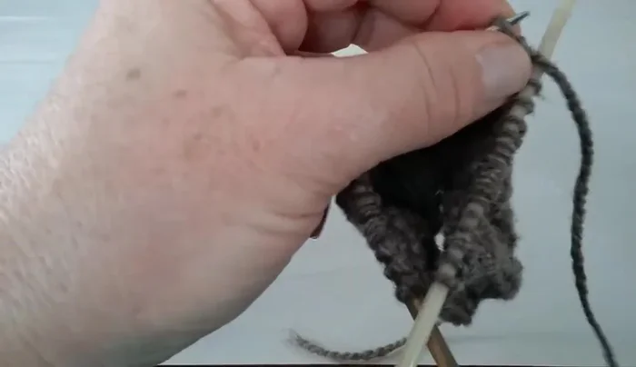 Continue knitting in the round on the inside until you reach the beginning of the thumbhole.