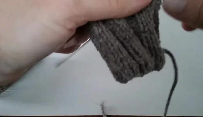 Join the stitches at the top to complete the thumbhole.