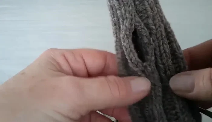 Join the stitches at the top to complete the thumbhole.