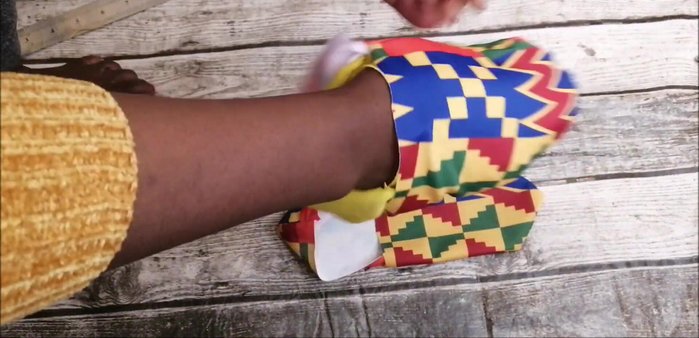 Insert the lining pieces into the outer fabric pieces, ensuring the wrong sides face each other. Sew around the edges of the sock to close the lining.