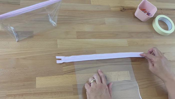 Sew the zipper: Using a zipper foot, sew along the edge of the zipper, close to the teeth, on one side of the zipper. Backstitch at the beginning and end.