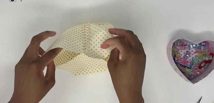 Place the lining fabric inside the main fabric with right sides together. Clip or pin around the edges to secure. Sew around the top edge.