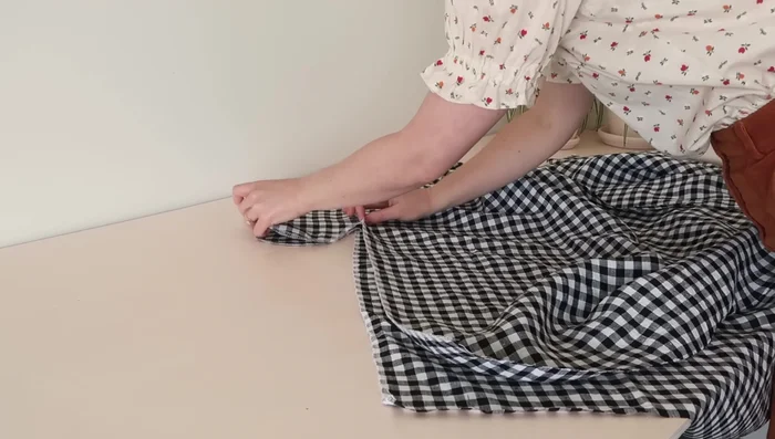 Stitch the main skirt pieces together at the side seams, enclosing the pockets.