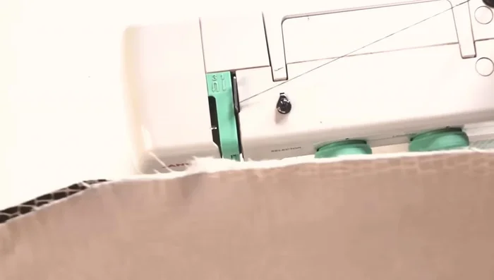 Top stitch all around (optional). Press the booby bed using a pressing cloth to prevent scorching.