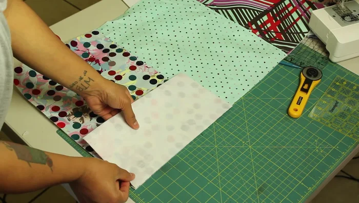 Attach side panels: Place the long fabric piece vertically. Attach one side panel by aligning the bottom edges, pinning from bottom to top, pivoting at corners, and stitching along three sides. Repeat for the other side panel.