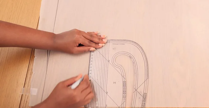 Design the waistband: Mark a 5-inch width, square it across, and mark a quarter of the tummy measurement. Connect the waistline and tummy points (adjust later if needed for looser fit). Add a notch for the waistband-lining seam.