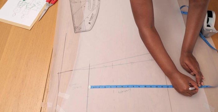 Trace and cut the outer skirt pattern piece: Trace the belly line, mark 19 inches downwards, extend the belly line by 16 inches, and mark 19 inches across. Draw an A-line silhouette and add a 1 cm seam allowance. Cut one piece on the fold for the front and use the same for the back (add seam allowance to the back center edge).